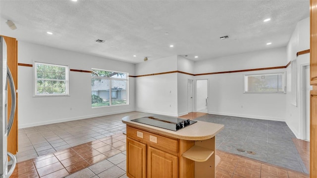 5370 Boxtree Ct, Dade City, FL 33523 - kitchen with open floor plan, light tile patterned floors, a textured ceiling, recessed lighting, and light countertops