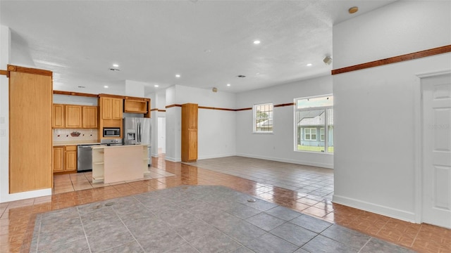 5370 Boxtree Ct, Dade City, FL 33523 - kitchen featuring stainless steel appliances, light tile patterned floors, recessed lighting, a center island, and open floor plan