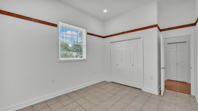 5370 Boxtree Ct, Dade City, FL 33523 - unfurnished bedroom featuring light tile patterned flooring, baseboards, a closet, and recessed lighting