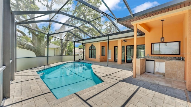 5370 Boxtree Ct, Dade City, FL 33523 - outdoor pool featuring a patio, a ceiling fan, glass enclosure, and area for grilling