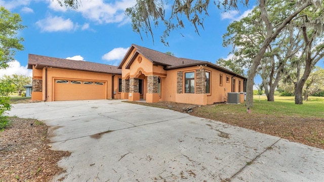 5370 Boxtree Ct, Dade City, FL 33523 - view of front of home featuring stucco siding, cooling unit, stone siding, an attached garage, and concrete driveway