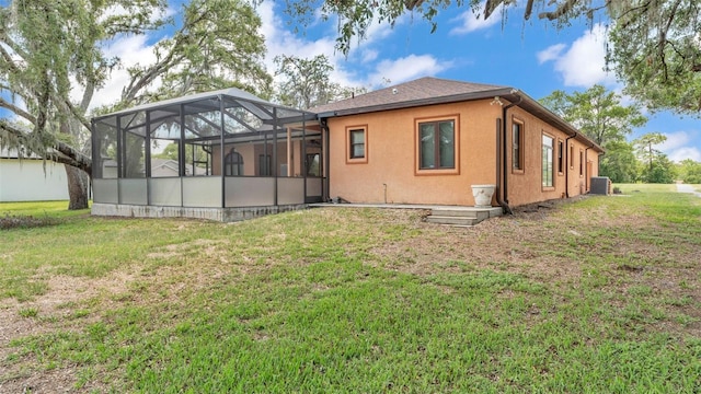 5370 Boxtree Ct, Dade City, FL 33523 - rear view of house featuring cooling unit, a lawn, and glass enclosure