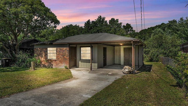 1017 Fleming Ave, Lakeland, FL 33815 - view of front of house featuring concrete driveway, a carport, and brick siding