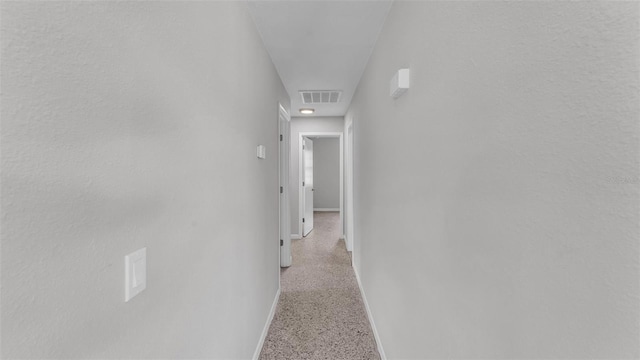 1017 Fleming Ave, Lakeland, FL 33815 - hallway featuring dark speckled floor and baseboards