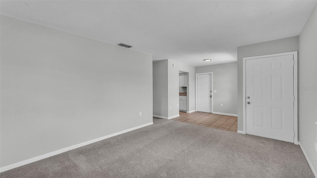 1017 Fleming Ave, Lakeland, FL 33815 - carpeted spare room featuring baseboards and tile patterned floors