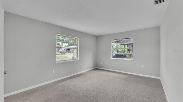 1017 Fleming Ave, Lakeland, FL 33815 - unfurnished room featuring healthy amount of natural light, carpet floors, and baseboards