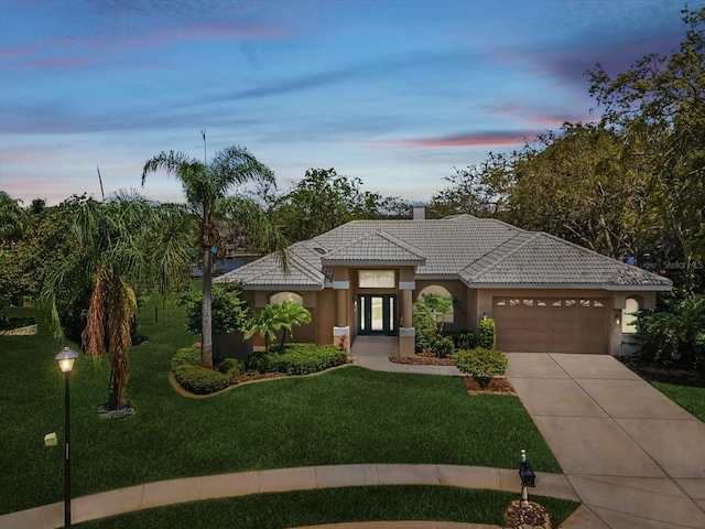 5903 Cachette De Riviera Ct, New Port Richey, FL 34655 - mediterranean / spanish home with a tiled roof, a garage, stucco siding, and a front yard