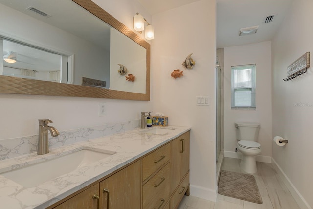 3626 Corsair Ct, New Port Richey, FL 34652 - full bath featuring double vanity, toilet, an enclosed shower, and baseboards