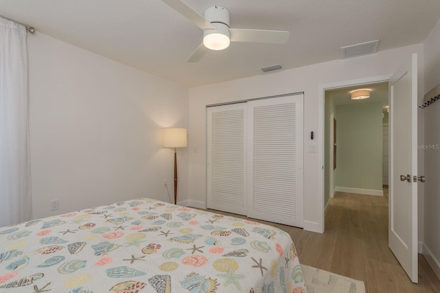 3626 Corsair Ct, New Port Richey, FL 34652 - bedroom with wood finished floors, a closet, a ceiling fan, and baseboards