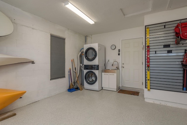 3626 Corsair Ct, New Port Richey, FL 34652 - laundry room with stacked washer / drying machine, concrete block wall, attic access, and cabinet space