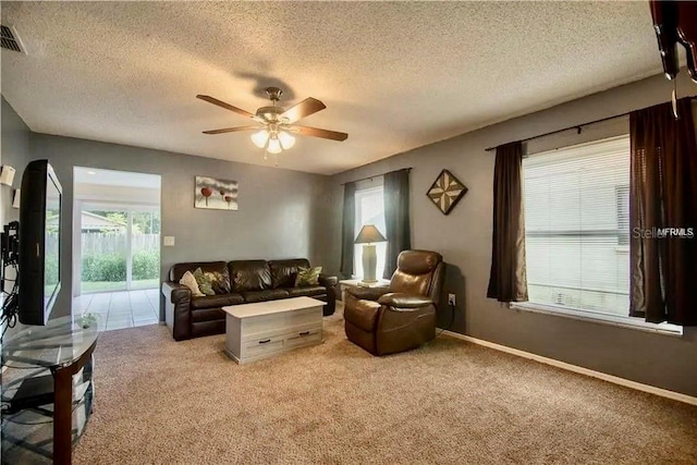 1410 Bramblewood Dr, Lakeland, FL 33811 - carpeted living area featuring ceiling fan, a textured ceiling, healthy amount of natural light, and baseboards