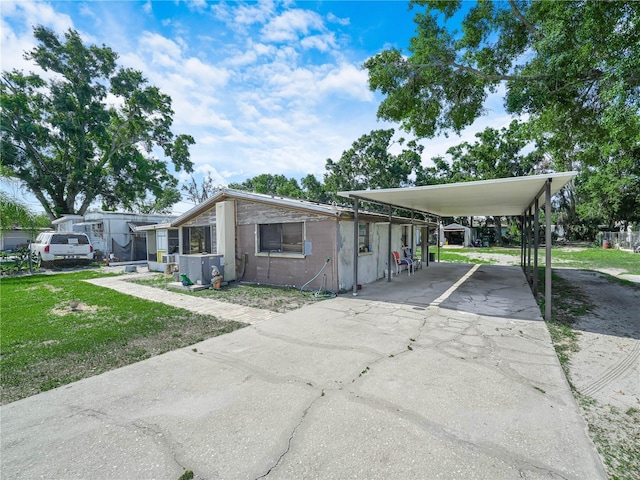 2120 Dille St, Lakeland, FL 33815 - view of front facade with driveway, a front lawn, and a carport