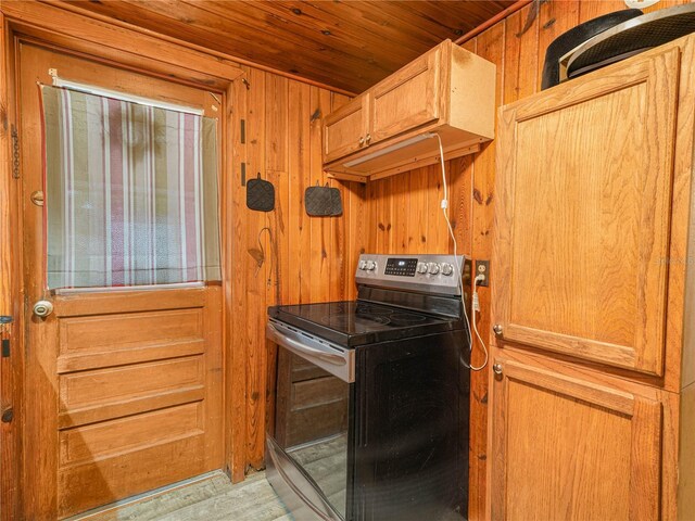 2120 Dille St, Lakeland, FL 33815 - kitchen featuring stainless steel electric stove, wood walls, wooden ceiling, and light wood-type flooring