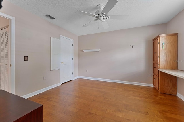 3487 Highland Fairways Blvd, Lakeland, FL 33810 - empty room featuring ceiling fan, wood finished floors, baseboards, and a textured ceiling