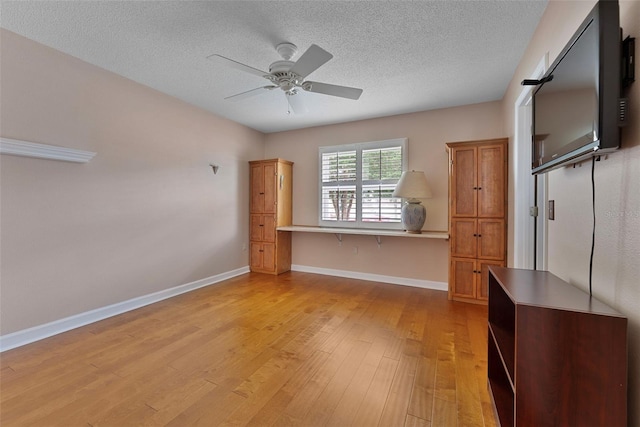 3487 Highland Fairways Blvd, Lakeland, FL 33810 - unfurnished bedroom featuring light wood-style flooring, a textured ceiling, baseboards, and ceiling fan