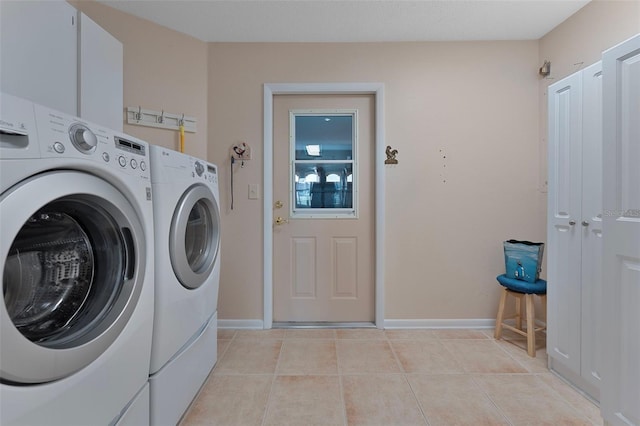 3487 Highland Fairways Blvd, Lakeland, FL 33810 - laundry area with washer and dryer, light tile patterned floors, and baseboards