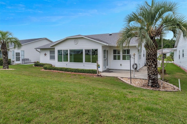 3487 Highland Fairways Blvd, Lakeland, FL 33810 - back of property featuring a yard, a patio area, and a shingled roof