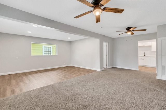3601 Ave R NW, Winter Haven, FL 33881 - empty room with ceiling fan, baseboards, light colored carpet, recessed lighting, and light wood finished floors