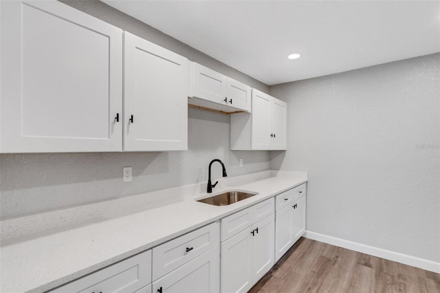 3601 Ave R NW, Winter Haven, FL 33881 - kitchen with a sink, light countertops, white cabinetry, and recessed lighting