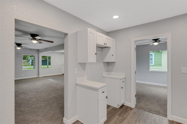 3601 Ave R NW, Winter Haven, FL 33881 - kitchen featuring white cabinets, ceiling fan, baseboards, light countertops, and recessed lighting