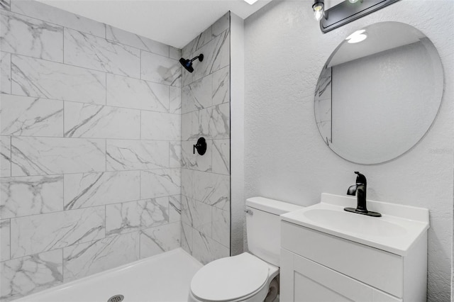 3601 Ave R NW, Winter Haven, FL 33881 - bathroom featuring vanity, toilet, tiled shower, and a textured wall