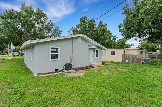 3601 Ave R NW, Winter Haven, FL 33881 - rear view of house with stucco siding and central AC