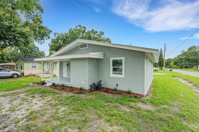 3601 Ave R NW, Winter Haven, FL 33881 - view of front facade with stucco siding and a front lawn