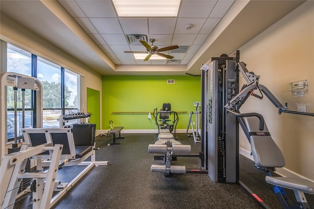 5927 Cormorant Ct, Lakeland, FL 33809 - exercise room with baseboards, a ceiling fan, a raised ceiling, and a paneled ceiling