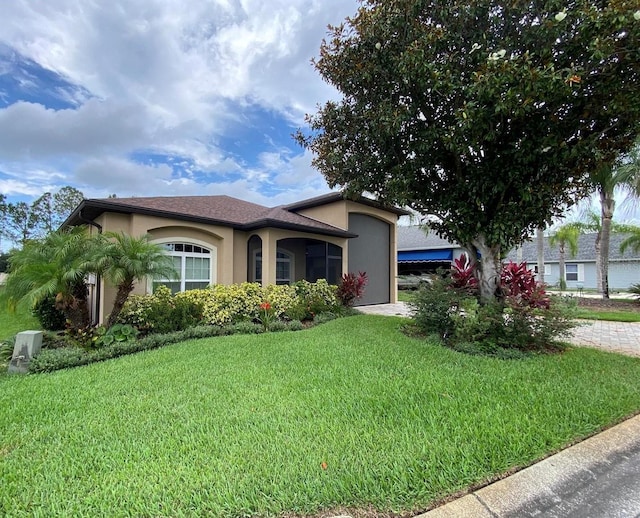 1167 Motorcoach Dr, Polk City, FL 33868 - ranch-style home featuring stucco siding and a front lawn