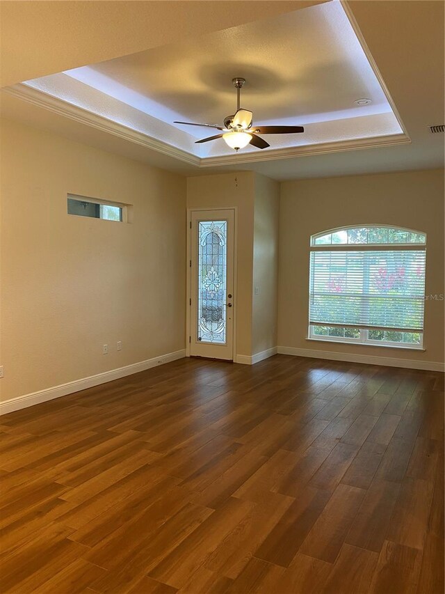 1167 Motorcoach Dr, Polk City, FL 33868 - spare room with a raised ceiling, wood finished floors, ceiling fan, and baseboards