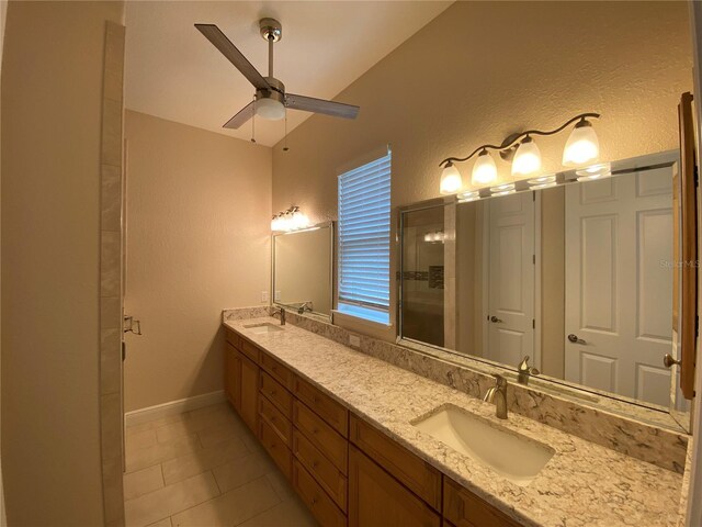 1167 Motorcoach Dr, Polk City, FL 33868 - bathroom featuring ceiling fan, double vanity, a textured wall, tile patterned floors, and a stall shower