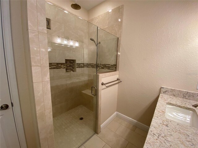 1167 Motorcoach Dr, Polk City, FL 33868 - full bathroom with a shower stall, vanity, tile patterned flooring, and baseboards