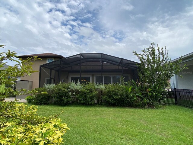 1167 Motorcoach Dr, Polk City, FL 33868 - rear view of house with stucco siding and glass enclosure