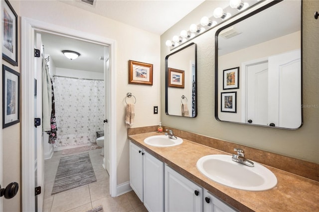 6789 Ashbury Dr, Lakeland, FL 33809 - bathroom featuring double vanity, toilet, tile patterned floors, and a shower with shower curtain