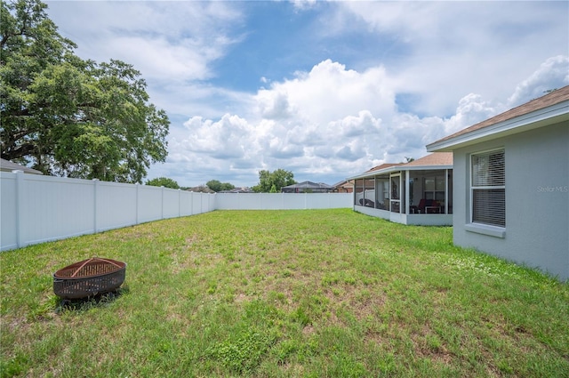 6789 Ashbury Dr, Lakeland, FL 33809 - view of yard featuring an outdoor fire pit and a sunroom