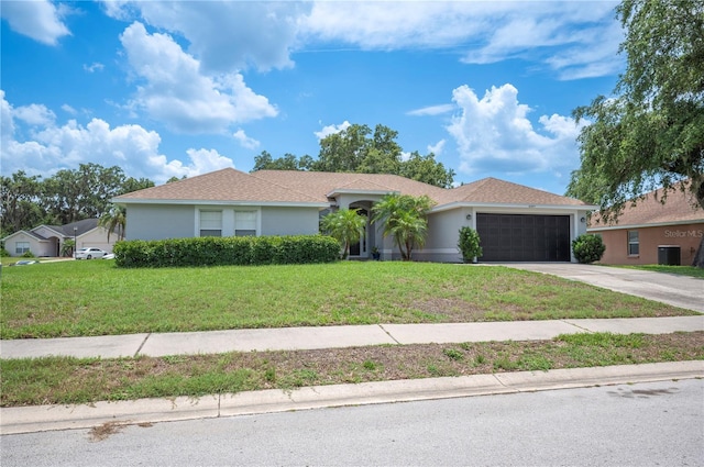 6789 Ashbury Dr, Lakeland, FL 33809 - ranch-style home with a garage, driveway, a front yard, central air condition unit, and stucco siding