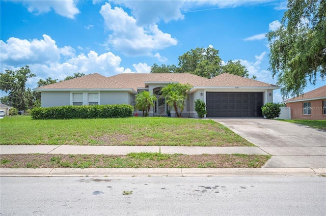 6789 Ashbury Dr, Lakeland, FL 33809 - ranch-style home featuring a garage, concrete driveway, a front lawn, and stucco siding
