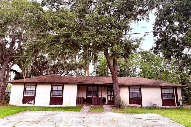 4507 Highland Ln, Lakeland, FL 33813 - view of front facade with a porch, stucco siding, and a front yard