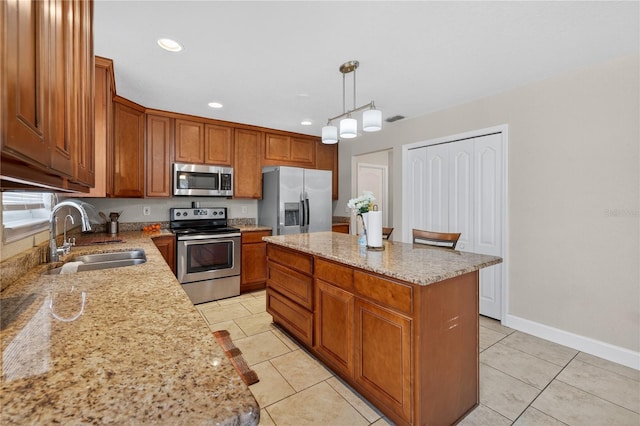 1922 Matthew Ct, Lakeland, FL 33813 - kitchen featuring appliances with stainless steel finishes, brown cabinets, a kitchen island, light tile patterned flooring, and recessed lighting