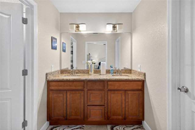 1922 Matthew Ct, Lakeland, FL 33813 - bathroom featuring double vanity and a textured wall