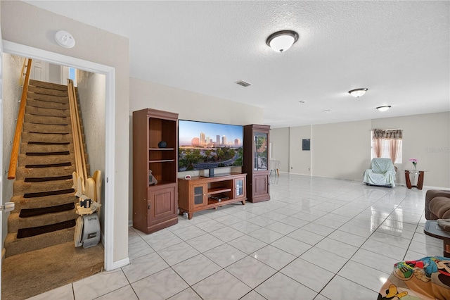 1922 Matthew Ct, Lakeland, FL 33813 - living area with light tile patterned flooring, a textured ceiling, and stairway