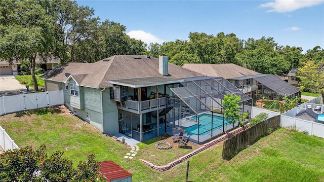 1922 Matthew Ct, Lakeland, FL 33813 - back of house with a fenced backyard, a gate, a fire pit, a patio area, and a chimney