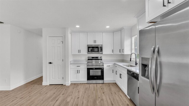 408 Sycamore St SW, Fort Meade, FL 33841 - kitchen with stainless steel appliances, a sink, light wood-type flooring, light countertops, and recessed lighting