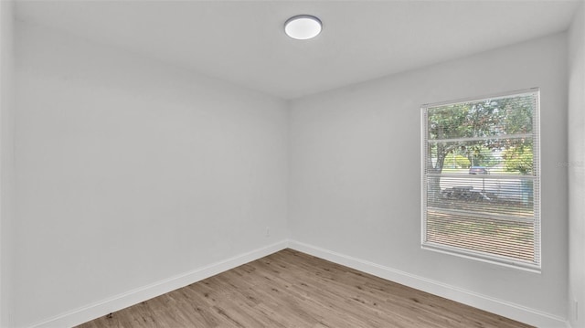 408 Sycamore St SW, Fort Meade, FL 33841 - unfurnished room with light wood-type flooring and baseboards