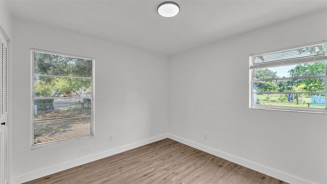 408 Sycamore St SW, Fort Meade, FL 33841 - empty room with light wood-style floors and baseboards