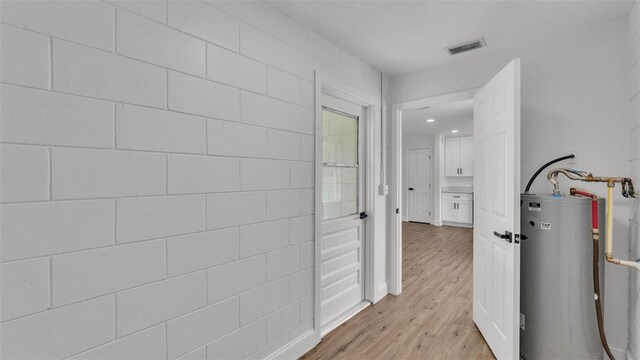 408 Sycamore St SW, Fort Meade, FL 33841 - hallway with electric water heater, light wood-style flooring, and recessed lighting