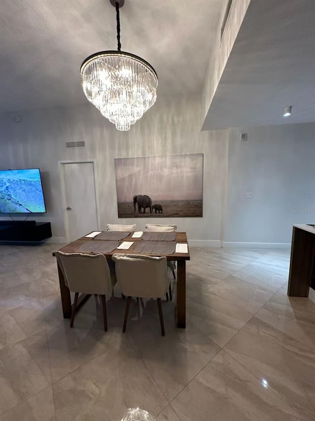 600 NE 27th St Unit 604, Miami, FL 33137 - dining area with a chandelier and baseboards