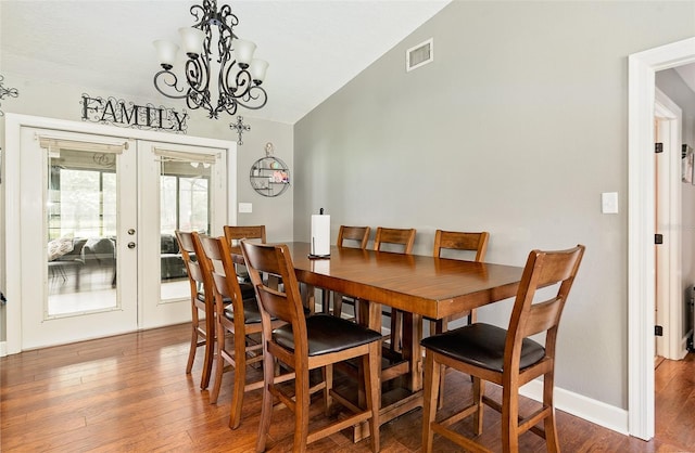 2331 D R Bryant Rd, Lakeland, FL 33810 - dining room featuring french doors, vaulted ceiling, wood finished floors, a chandelier, and baseboards