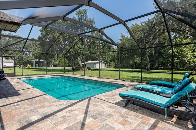 2331 D R Bryant Rd, Lakeland, FL 33810 - swimming pool with a patio, a lawn, and glass enclosure