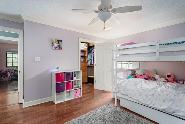 2331 D R Bryant Rd, Lakeland, FL 33810 - bedroom with crown molding, wood finished floors, multiple windows, a textured ceiling, and a spacious closet